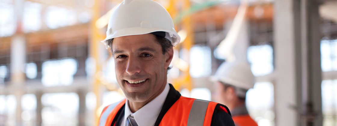 Businessman at construction site - ERP for Main Contractors in the Building Industry