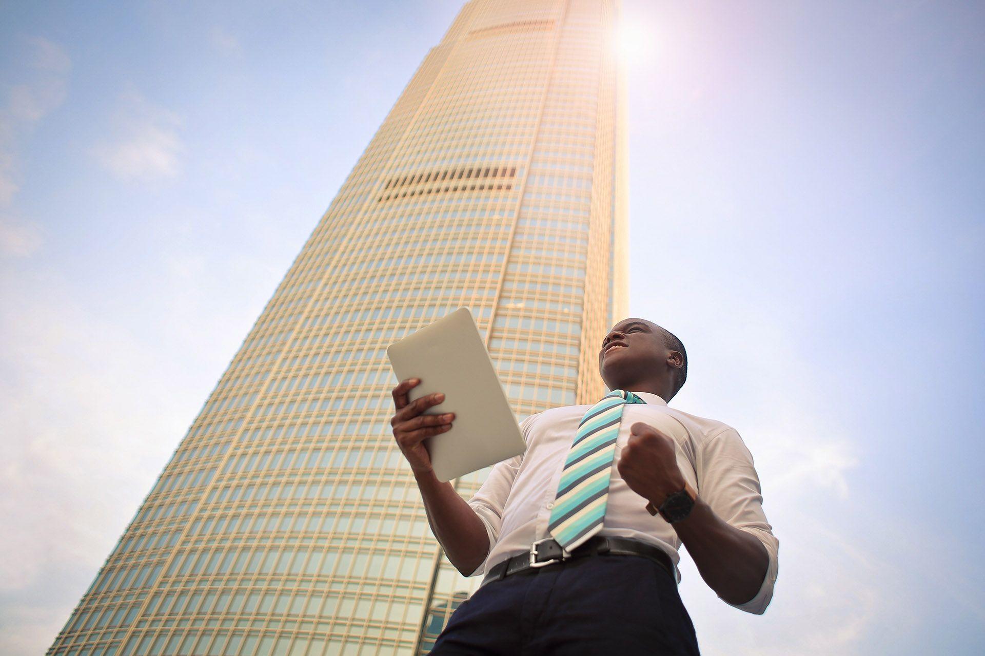 Man in front of a skyscraper
