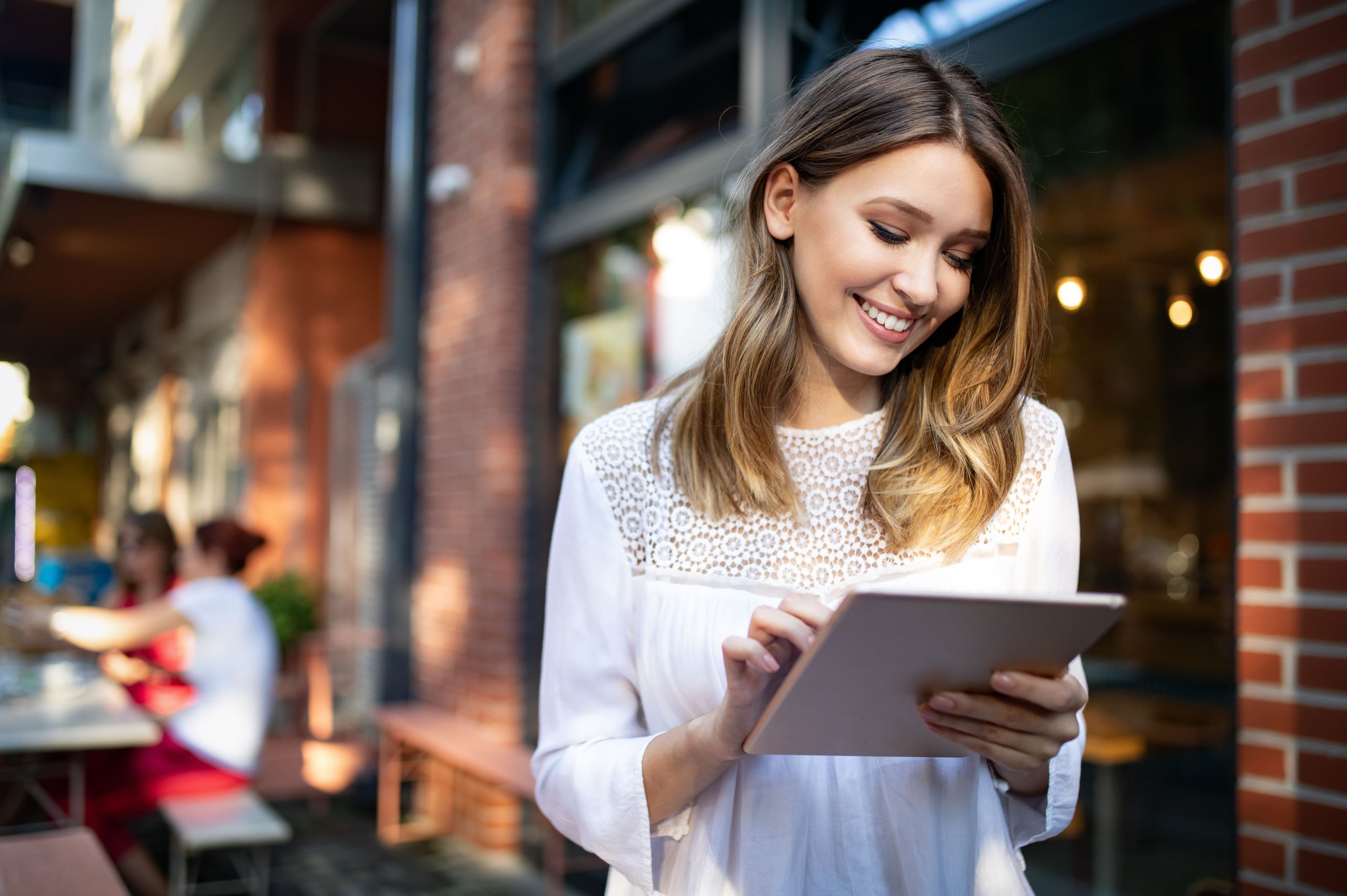 woman on her tablet outside